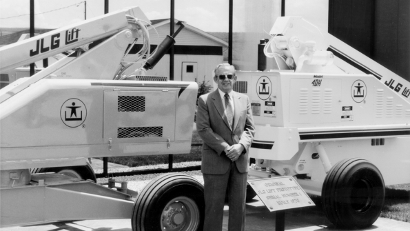 John L Grove showing his original JLG 1 boomlift at a trade show