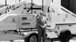 John L. Grove showing his original JLG 1 boomlift at a trade show.