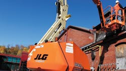 A worker using a JLG 340 AJ aerial work platform on a jobsite somewhere in the United States A worker using a JLG 340 AJ aerial work platform on a jobsite somewhere in the United States