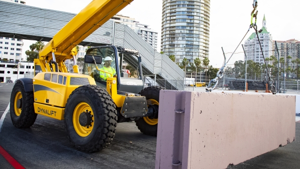 A Gehl telehandler moving a concrete block in Long Beach preparing the race track