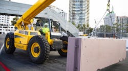 A Gehl telehandler moving a concrete block in Long Beach, preparing the race track.