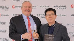 Manitowoc CEO Barry Pennypacker shares a toast with I.H. Kim, president of Shinwoo Development Co., a major player in the distribution of Potain Cranes in South Korea.