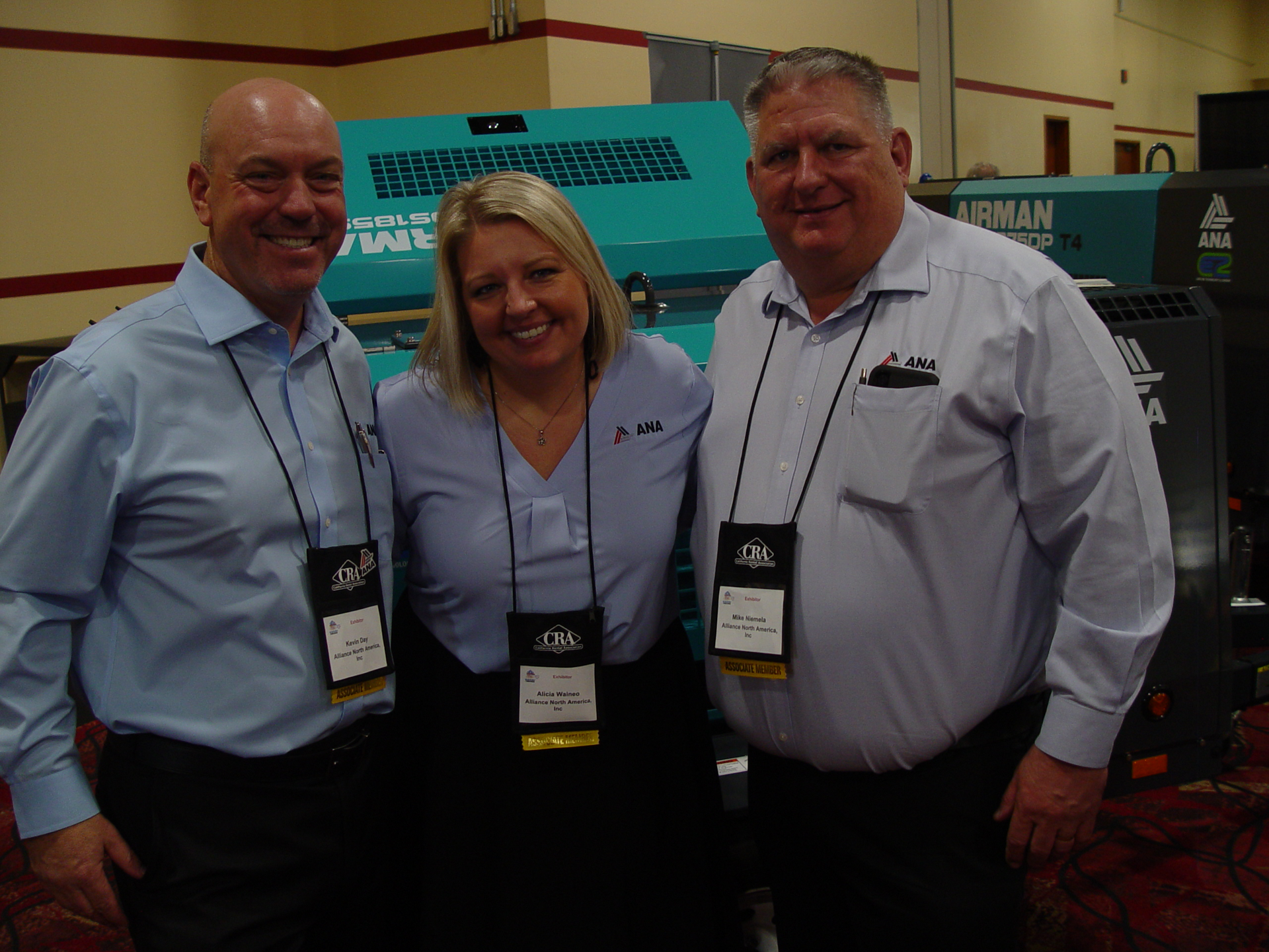 Kevin Day, executive vice president of Alliance North America; Alicia Waineo, vice president of operations; and CEO Mike Niemela on the trade show floor.