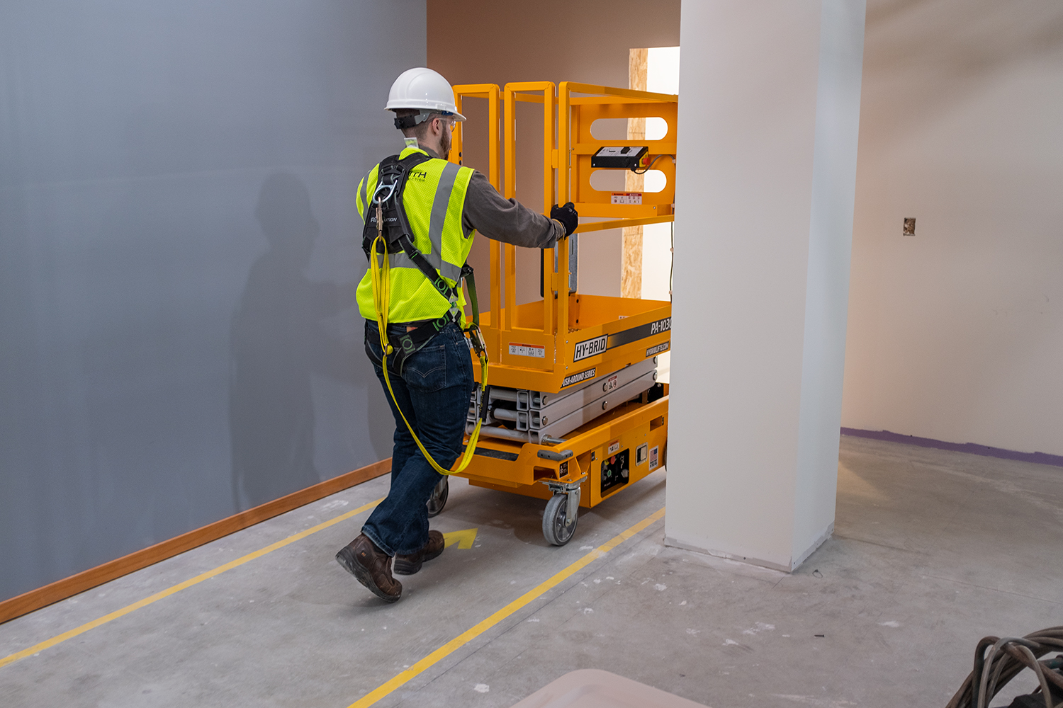 Low-level scissor lifts are easier to move through doorways, while ladders are heavier as they get taller and more awkward to move.