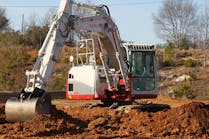 Takeuchi excavator digging up dirt