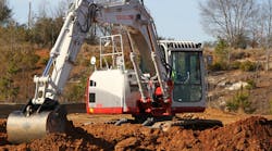 Takeuchi excavator digging up dirt