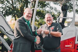 John Uesseler, CEO, Empower College & Career Center, left, receives the key to the excavator from Jeff Stewart, president, Takeuchi-US. John Uesseler, CEO, Empower College & Career Center, left, receives the key to the excavator from Jeff Stewart, president, Takeuchi-US.