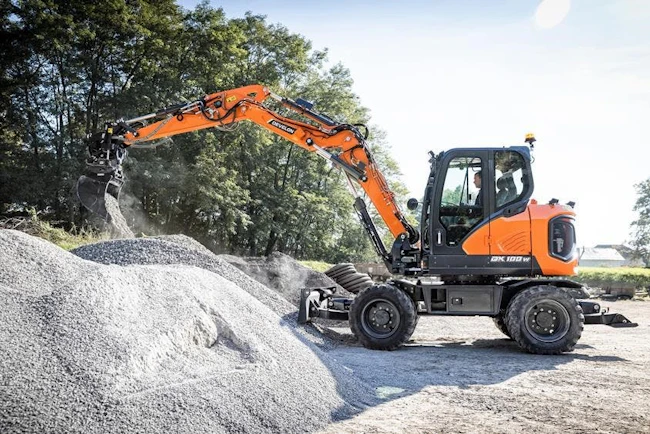 667b28ba51e91e8586e3cebf Develop Dx100w7 Mini Wheeled Excavator