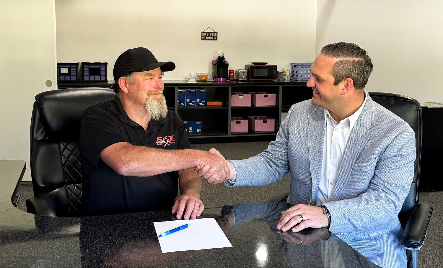George Boeger of G & T (left) and Spencer McHugh of Deutz shake hands over the new agreement.
