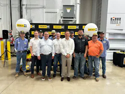 Peter Holt (beige pants, white shirt) joins staffers at Holt Cat's new Waxahachie, Texas, facility.