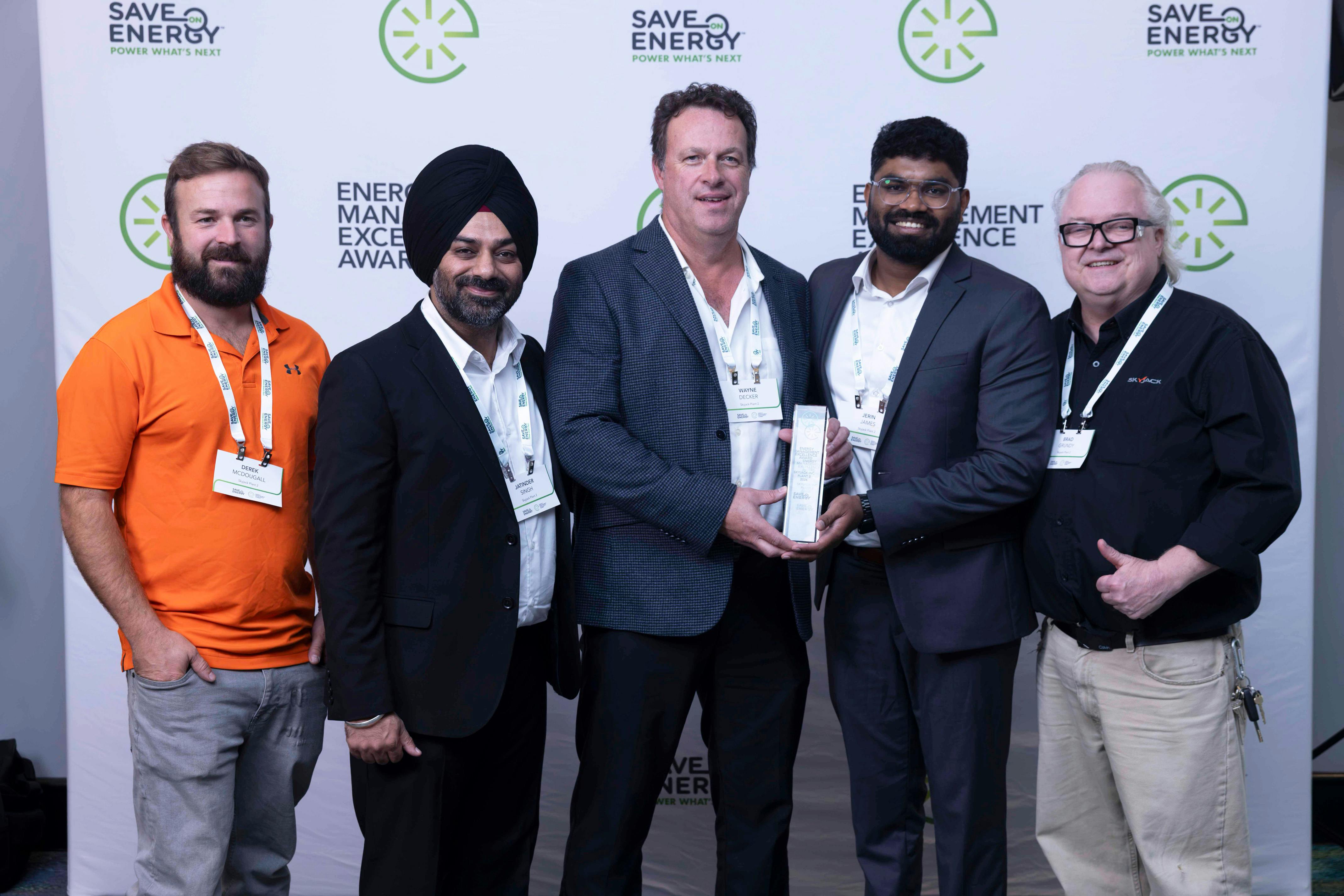 Skyjack Plant 2 Energy Team Members (L to R) Derek McDougall (Maintenance Support), Jatinder Singh (Engineering Support), Wayne Decker (Executive Sponsor), Jerin James (Energy Manager), and Brad Grundy (Maintenance Support) attend the IESO Save on Energy 2026 Energy Management Excellence Summit at the Toronto Congress Centre in Etobicoke, Ontario.